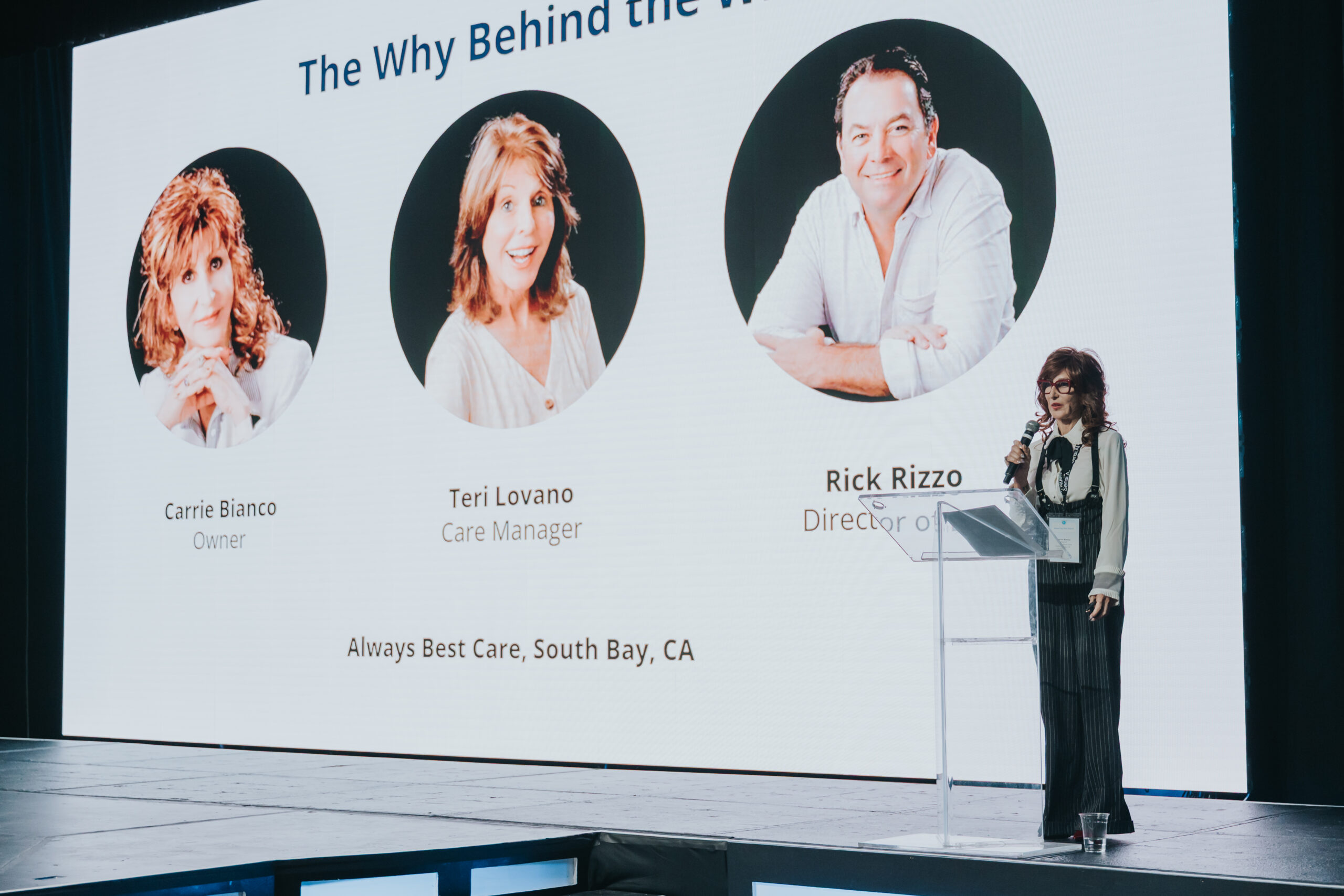 A woman speaking onstage on senior care technology