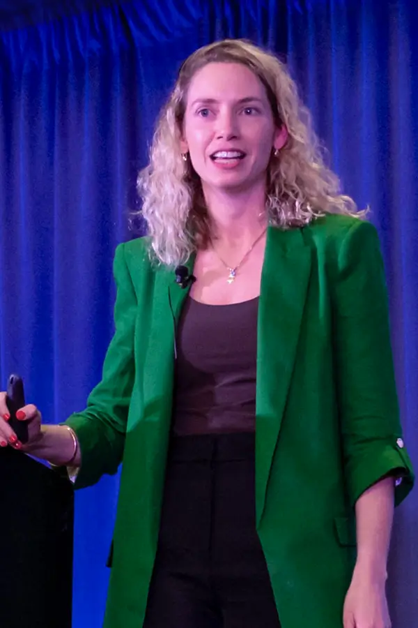 Romi Gubes speaking at a live event